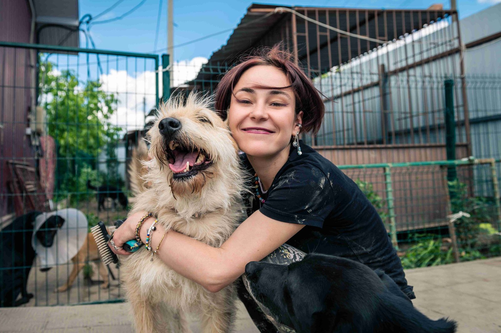 Foster caregiver embracing a shelter dog at home